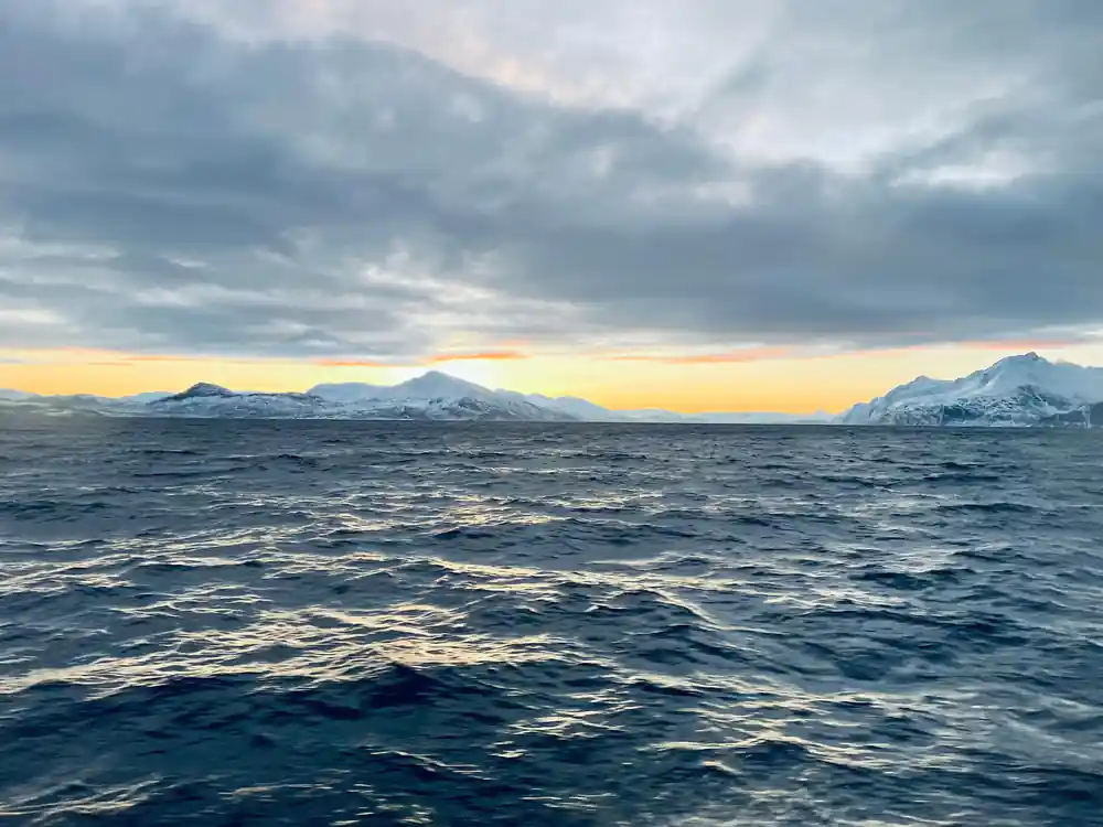 Multiple snow-capped mountains across distant horizon